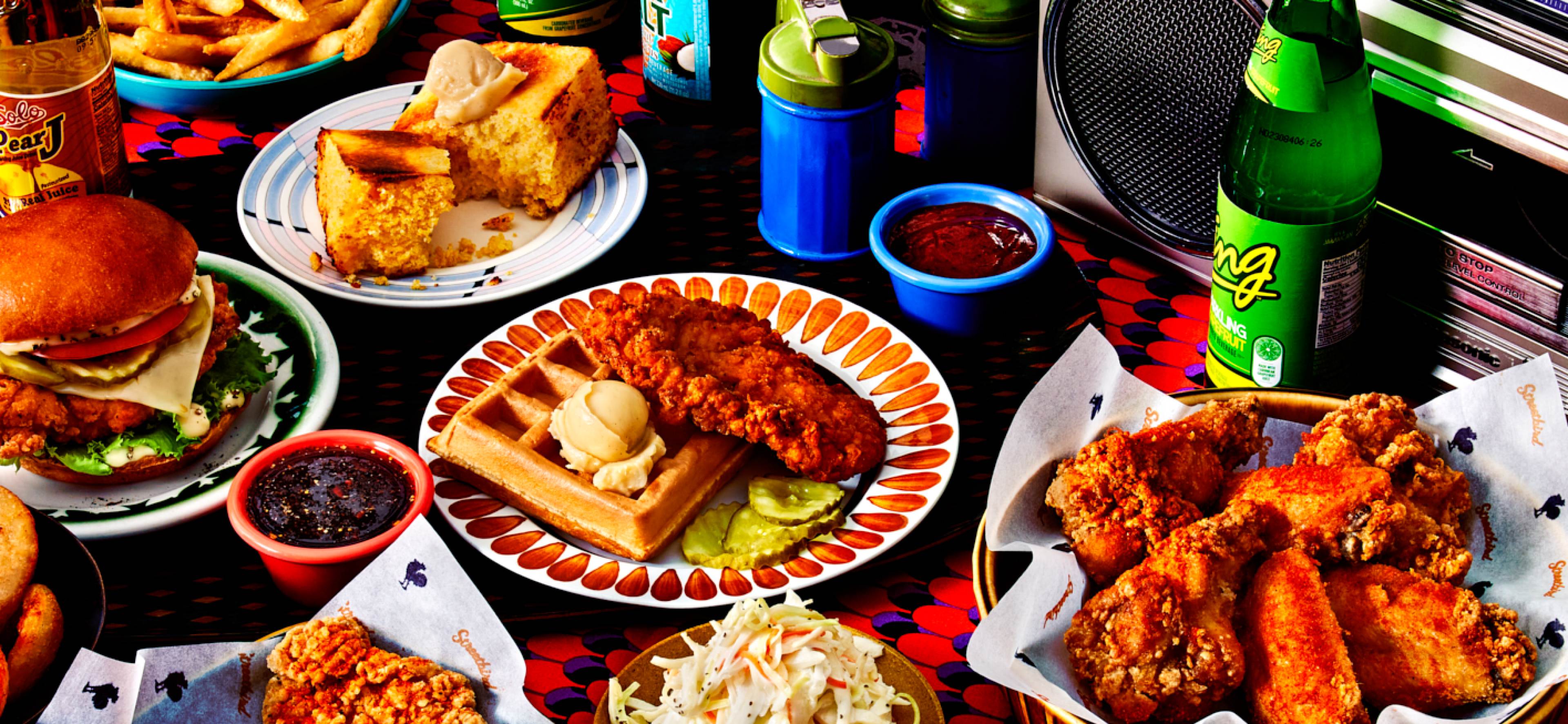 A delicious spread of food from Wonder, including a fried chicken sandwich, cole slaw, and wings